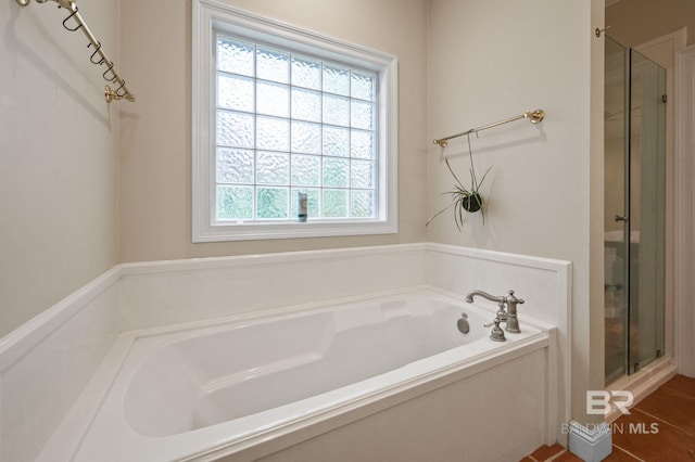 bathroom with independent shower and bath and tile patterned flooring