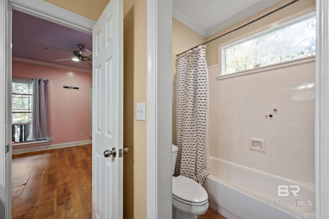 bathroom featuring toilet, hardwood / wood-style floors, a healthy amount of sunlight, and shower / bathtub combination with curtain