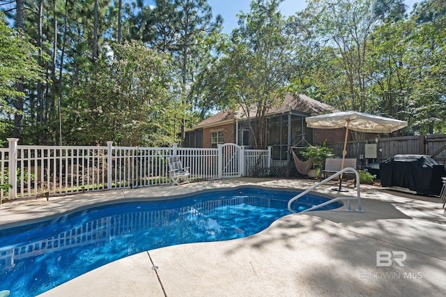 view of swimming pool with a patio and a sunroom