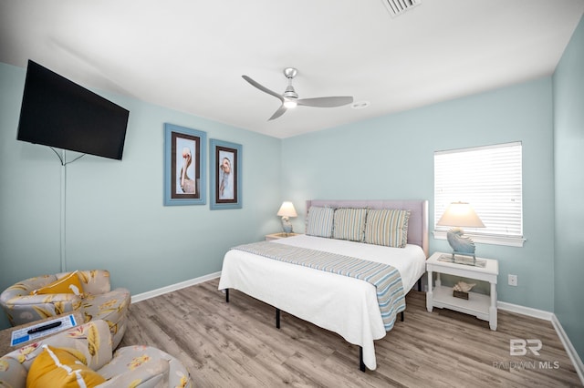 bedroom featuring visible vents, wood finished floors, baseboards, and ceiling fan