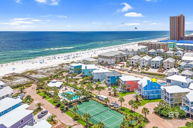 birds eye view of property featuring a beach view and a water view