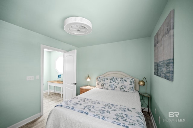 bedroom featuring baseboards and wood finished floors