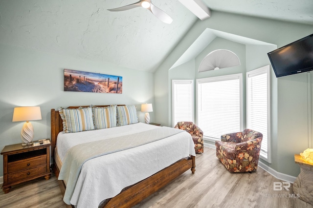 bedroom featuring baseboards, a ceiling fan, wood finished floors, and vaulted ceiling with beams