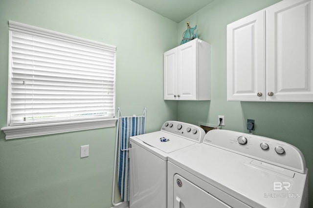 washroom with cabinet space and washer and clothes dryer