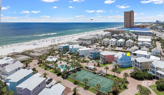 aerial view with a water view and a beach view