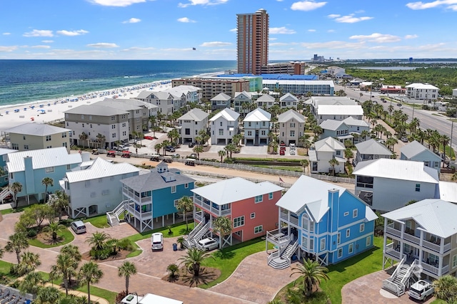 drone / aerial view with a beach view and a water view