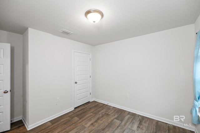 empty room with dark wood-type flooring