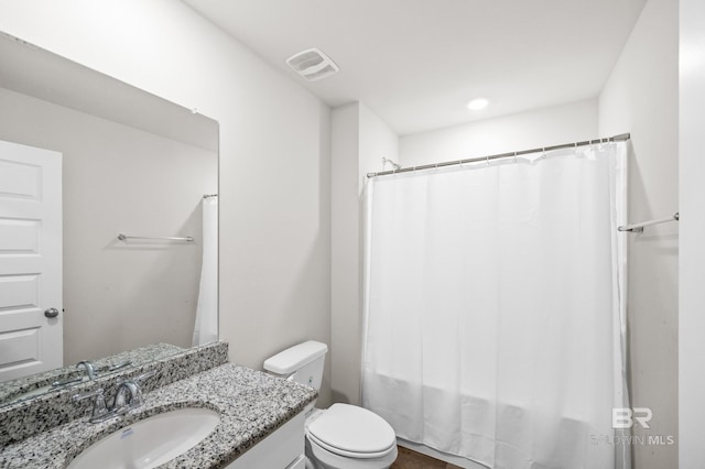 full bathroom with vanity, shower / bath combo with shower curtain, and toilet