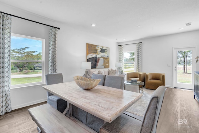 dining space with light hardwood / wood-style floors and a wealth of natural light