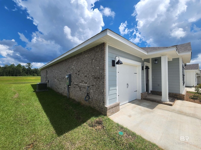 view of property exterior featuring cooling unit, a garage, and a yard