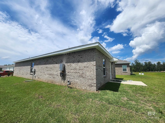 view of side of property with a yard