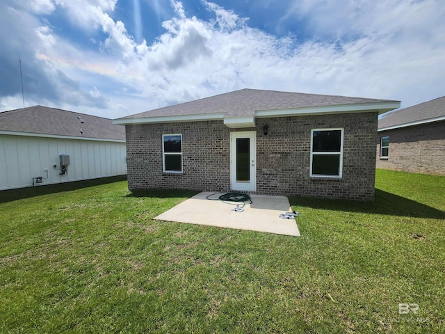 rear view of house featuring a yard and a patio