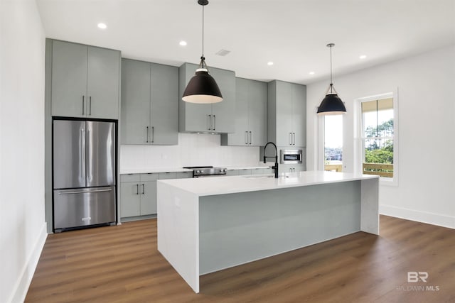 kitchen featuring dark wood-style floors, light countertops, baseboards, gray cabinetry, and appliances with stainless steel finishes
