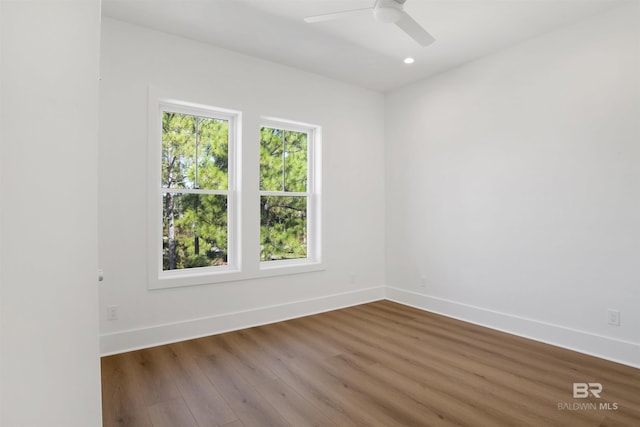 empty room with recessed lighting, wood finished floors, baseboards, and ceiling fan