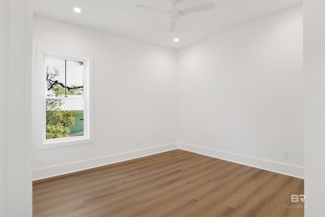 spare room featuring baseboards, a ceiling fan, wood finished floors, and recessed lighting
