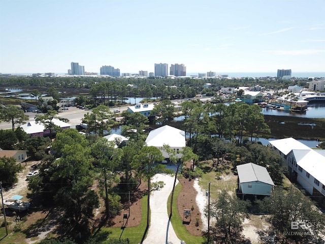 birds eye view of property with a water view and a view of city