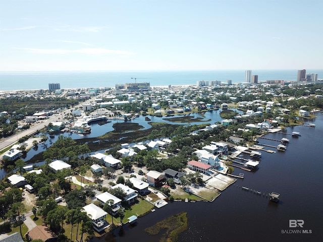 drone / aerial view featuring a city view and a water view