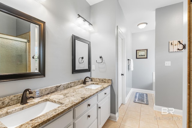 bathroom featuring tile patterned flooring, a shower with shower door, and vanity