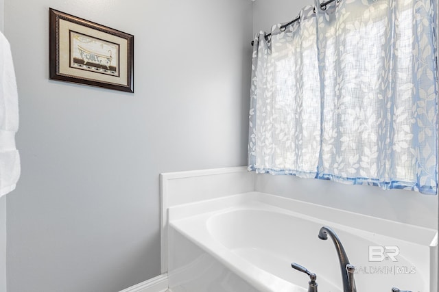 bathroom with a tub to relax in