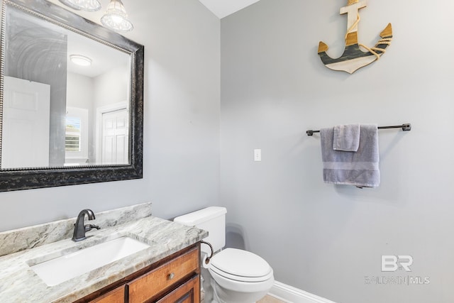 bathroom with toilet and vanity