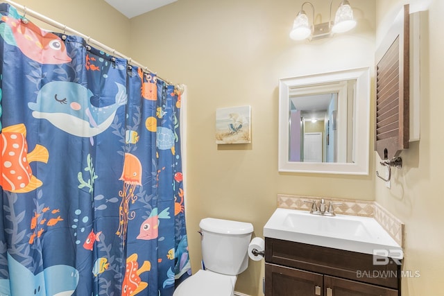 bathroom featuring toilet, a shower with curtain, and vanity