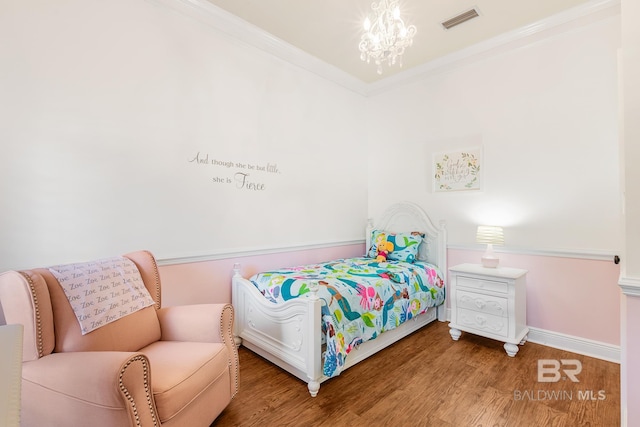 bedroom with a chandelier, wood-type flooring, and ornamental molding