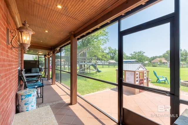 unfurnished sunroom with plenty of natural light and wooden ceiling