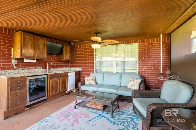 interior space with brick wall, wood ceiling, wine cooler, and sink