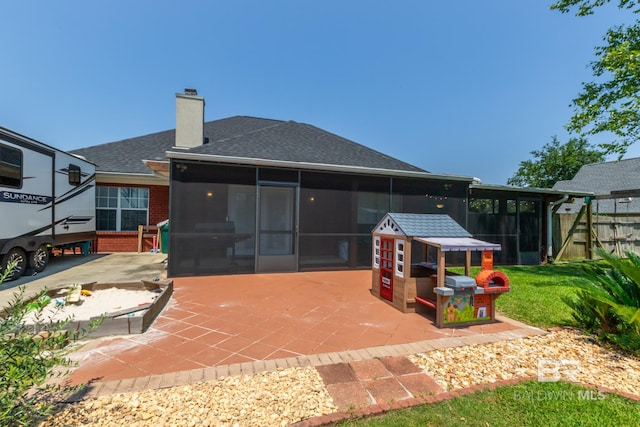 back of house with a patio area and a sunroom