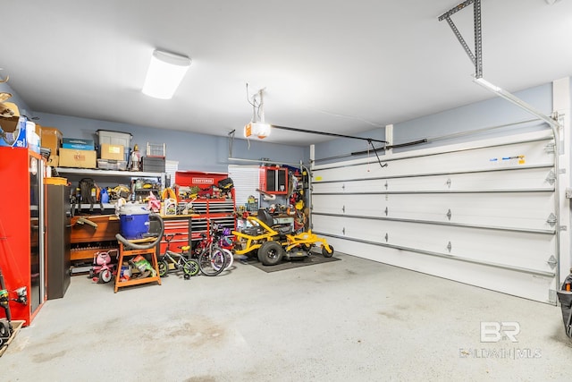 garage with a garage door opener and a workshop area