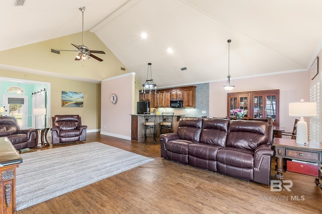 living room featuring ceiling fan, light hardwood / wood-style floors, beam ceiling, ornamental molding, and high vaulted ceiling