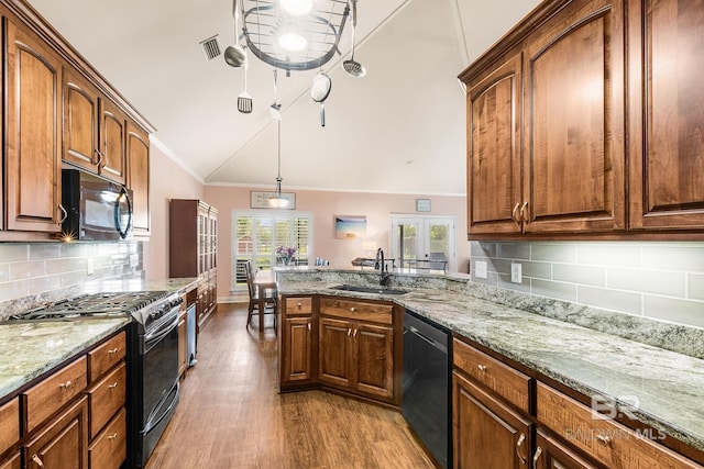 kitchen with dishwashing machine, lofted ceiling, backsplash, crown molding, and stainless steel range with gas stovetop