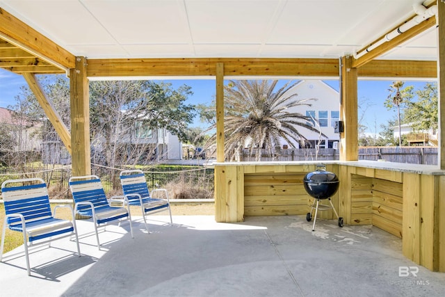 view of patio / terrace with fence and a grill