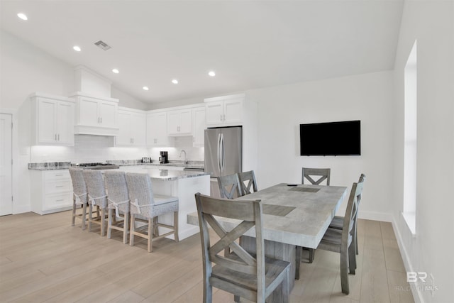 dining area featuring lofted ceiling, light wood-style flooring, visible vents, and recessed lighting