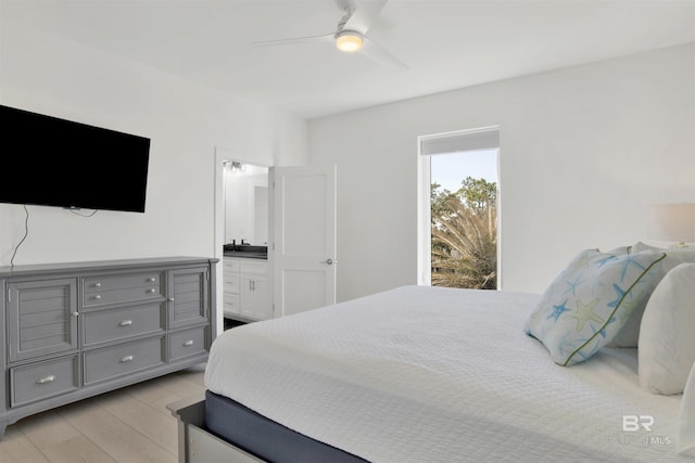 bedroom featuring connected bathroom, light wood-style flooring, and a ceiling fan