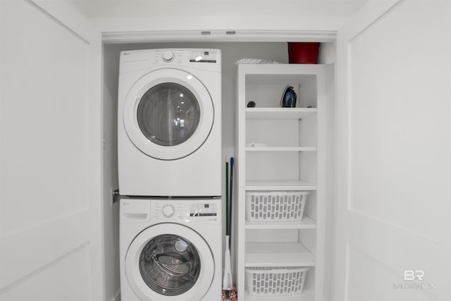 washroom with stacked washer / drying machine and laundry area