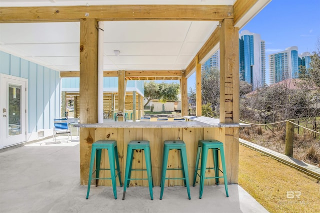 view of patio / terrace featuring a city view and exterior bar