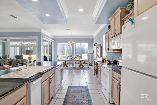 kitchen featuring white appliances, light tile patterned floors, dark countertops, ornamental molding, and a sink