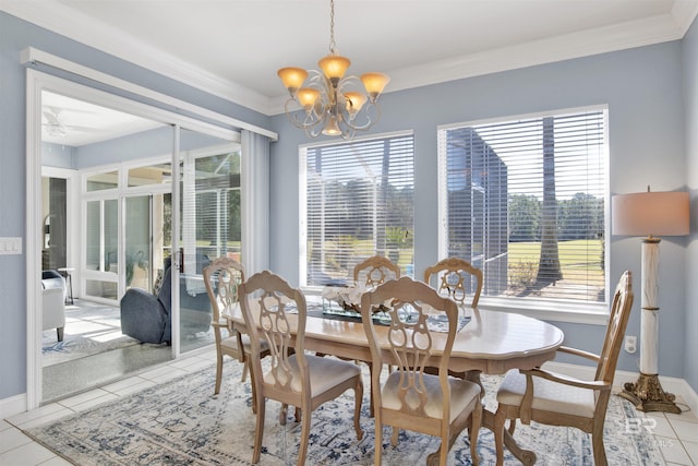 dining space with light tile patterned floors, plenty of natural light, a chandelier, and crown molding