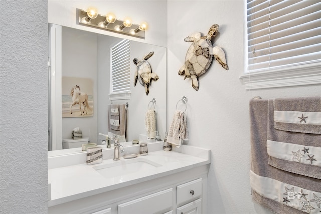 bathroom featuring toilet and vanity