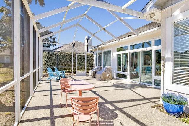 unfurnished sunroom featuring vaulted ceiling