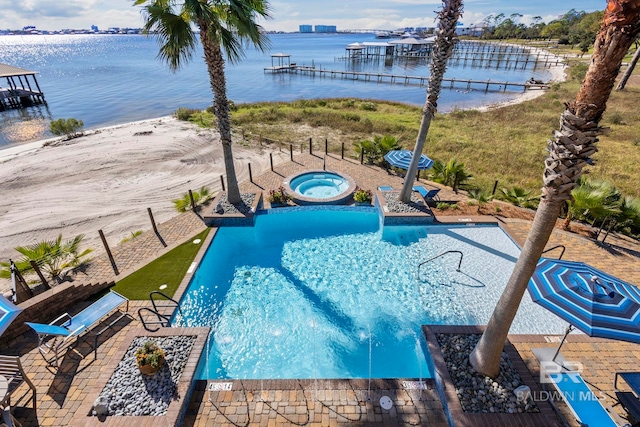 pool featuring a patio area, a community hot tub, and a water view