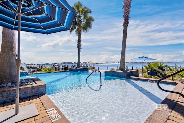 community pool featuring a water view and a patio area