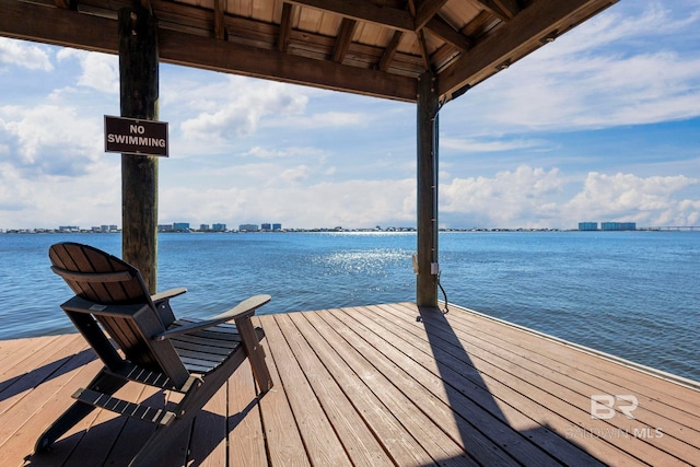 dock area featuring a view of city and a water view