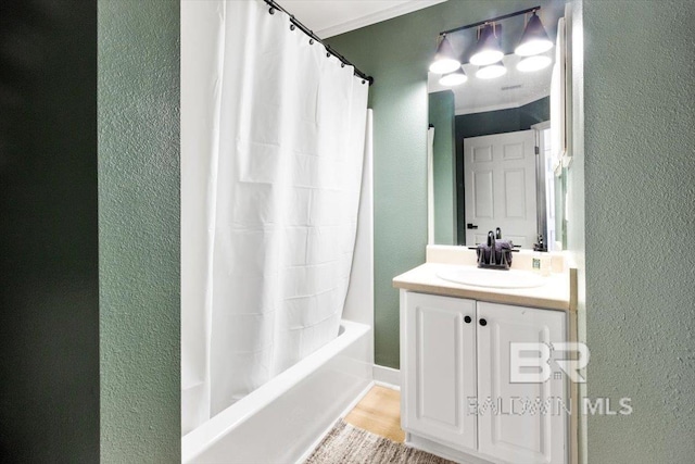 bathroom featuring shower / tub combo with curtain, vanity, hardwood / wood-style floors, and crown molding