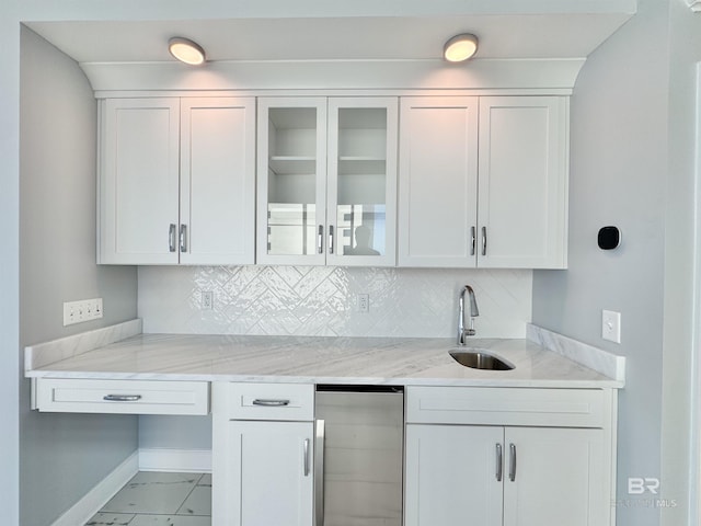 kitchen featuring white cabinetry, refrigerator, and tasteful backsplash