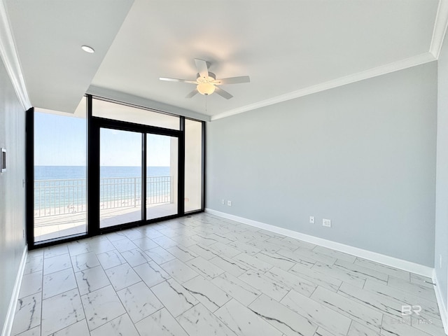 empty room with a ceiling fan, baseboards, ornamental molding, a water view, and marble finish floor