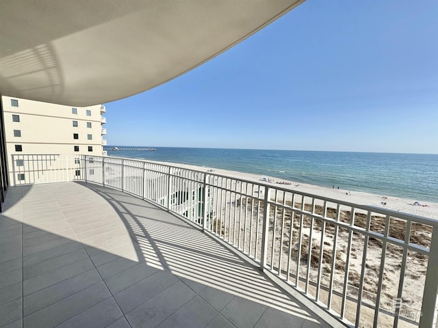 balcony with a view of the beach and a water view