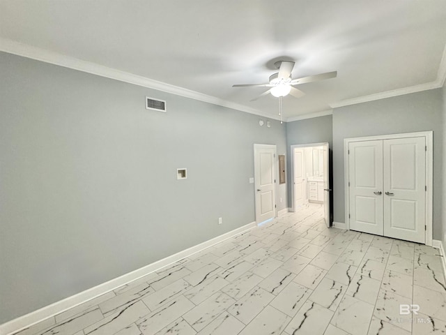 spare room with visible vents, ceiling fan, baseboards, ornamental molding, and marble finish floor