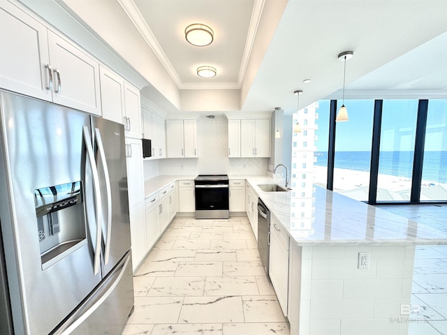 kitchen with a peninsula, ornamental molding, a sink, appliances with stainless steel finishes, and marble finish floor